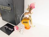 a small figurine of a woman sitting on top of a box