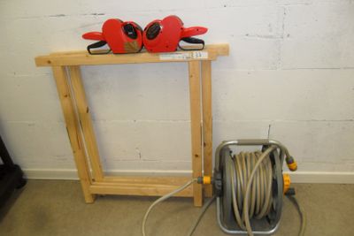 a picture of a fire hydrant and a hose on a stand