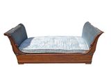 a wooden bench with a blue cushion on top of it