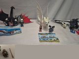 a picture of a table with legos and dragon figurines on it