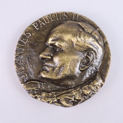 a close up of a coin with a man ' s face on it