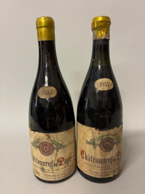 two bottles of wine sitting next to each other on a table