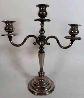 silver plated candelabra with three candles on a white background