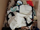 a cardboard box filled with clothes and a pair of shoes
