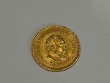 an image of a gold coin sitting on top of a white surface