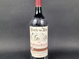 a bottle of red wine sitting on top of a table