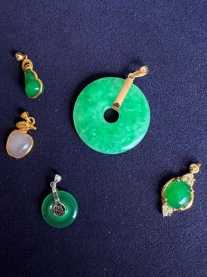 several pieces of jewelry including a donut, a pendant, and a pendant