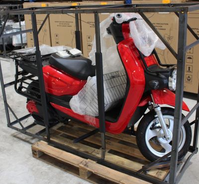 un scooter posé sur une palette dans un entrepôt