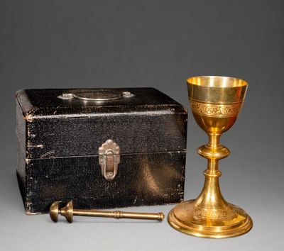brass chalicet and box on a grey background