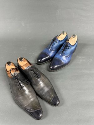 two pairs of men ' s shoes on a grey surface