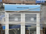 a blue and white house sitting on top of a pallet