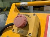 a close up of a yellow machine with a sign on it