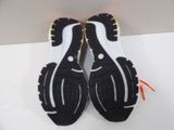 pair of black and white running shoes on a white surface