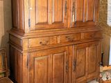 a large wooden cabinet in the middle of a room