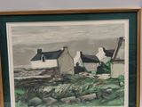 framed picture of a painting of a cottage on the coast