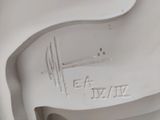 underside view of a white porcelain sculpture of a horse and rider
