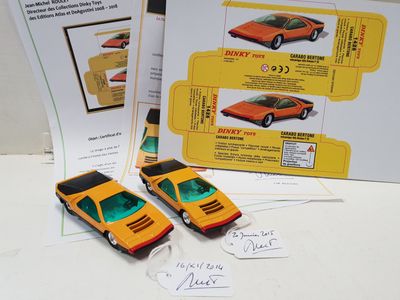 two toy cars sitting next to each other on a table