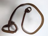a brown leather strap with a metal hook attached to it