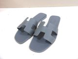 pair of blue sandals on a white surface with a white background