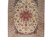 an antique persian rug with a medallion design on a cream ground