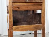 a wooden cabinet with a glass door on top of it