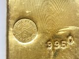 an image of a close up of a gold bar on a white surface
