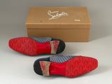 pair of red and blue striped shoes in front of a cardboard box