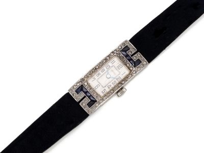 an art deco watch with a black leather band and a diamond bezel