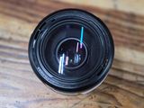 a close up of a camera lens on a wooden table