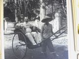 a black and white photo of a man and a woman riding in a horse drawn carriage