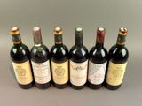 six bottles of wine are lined up in a row on a table