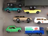 many toy cars in a display case on the floor