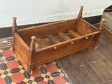 a small wooden bed with a wooden frame on the floor