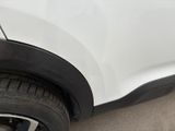 a close up of a white car with a flat tire