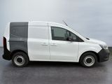 a small white van parked on a parking lot