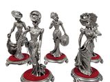 three silver figurines of a woman with a basket of flowers
