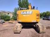the back end of a yellow excavator sitting on top of a pile of dirt