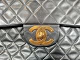 a black bag with a gold logo on it