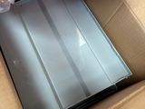 a laptop in a box with plastic wrap on top of it