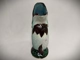 a vase with a fish on it on a white surface
