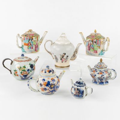many different types of teapots and cups on the table