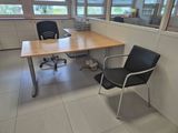 a desk with a chair and a computer on it in an office