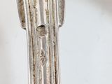 a silver spoon and fork on a white table