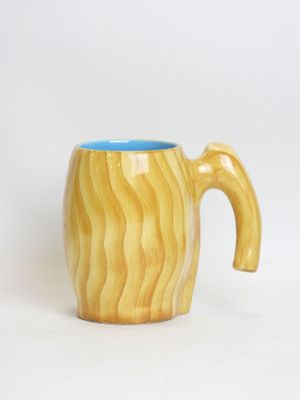 a wooden mug with a handle on a white background