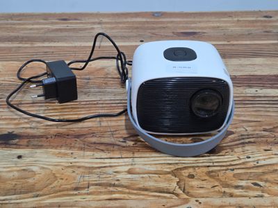 a small projector sitting on top of a wooden table