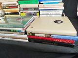 many books stacked on top of each other on a table