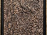 a close up of a metal plaque with a picture of a man on a horse