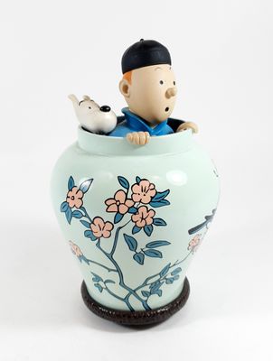 a small figurine of a man sitting in a vase