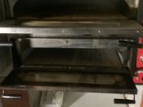 a pizza oven that is sitting in a kitchen