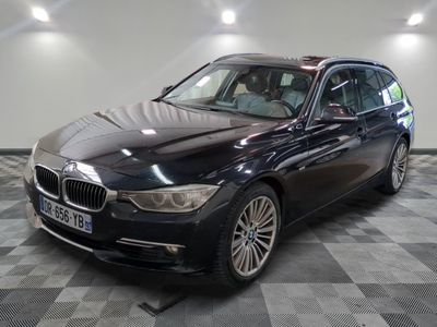 une photo d'une voiture bmw noire garée dans un garage